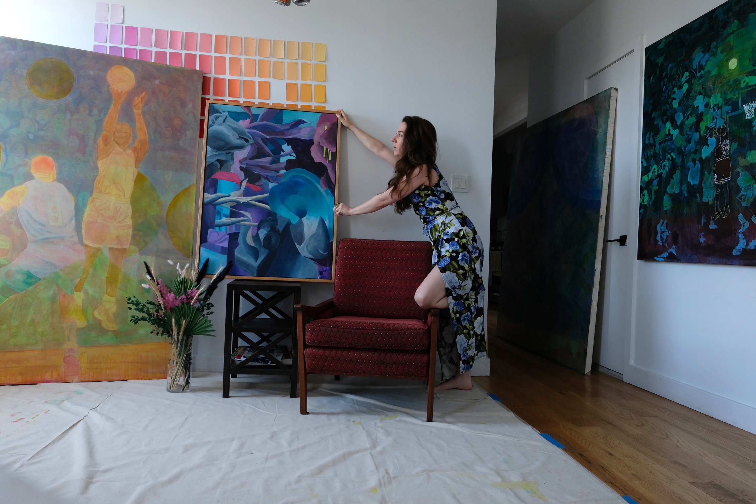Carole Vaudable placing artwork in a home